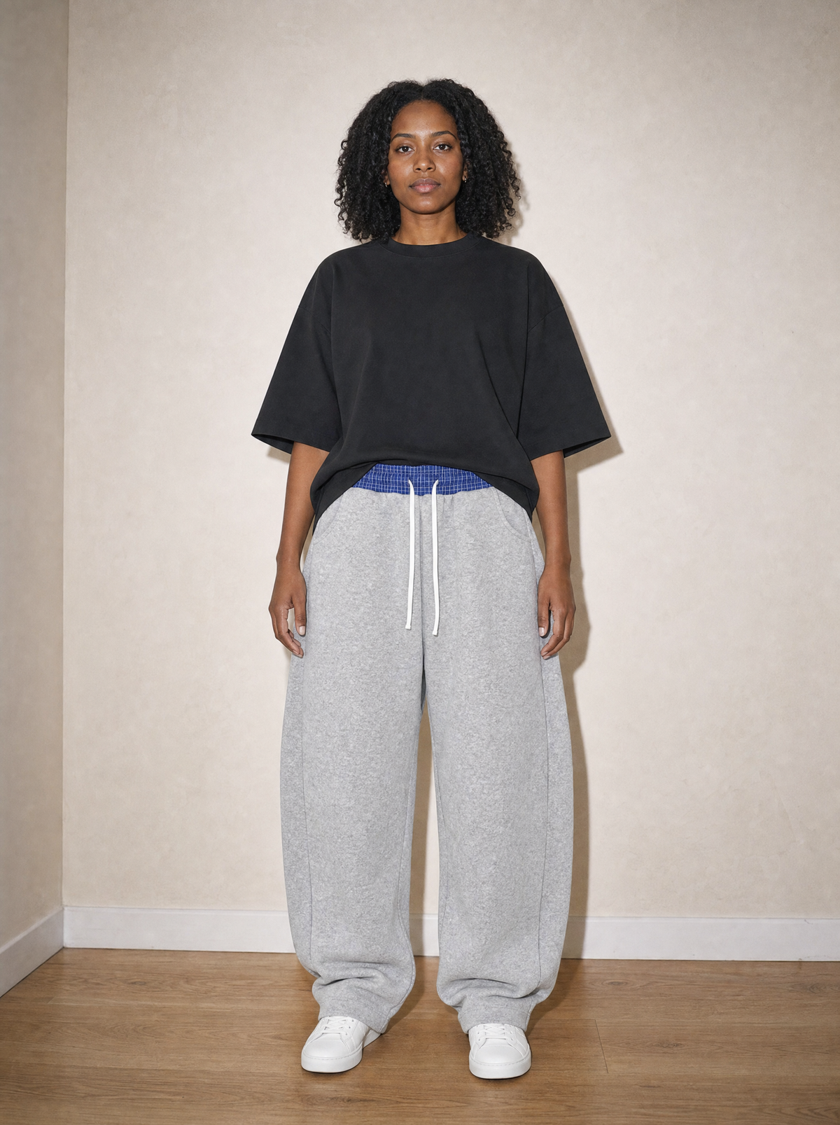 Home & Away Plaid Barrel Sweatpant in Flower Gray, front view, worn against the apartment wall: 350 gsm knit with a woven plaid waistband and a true barrel leg