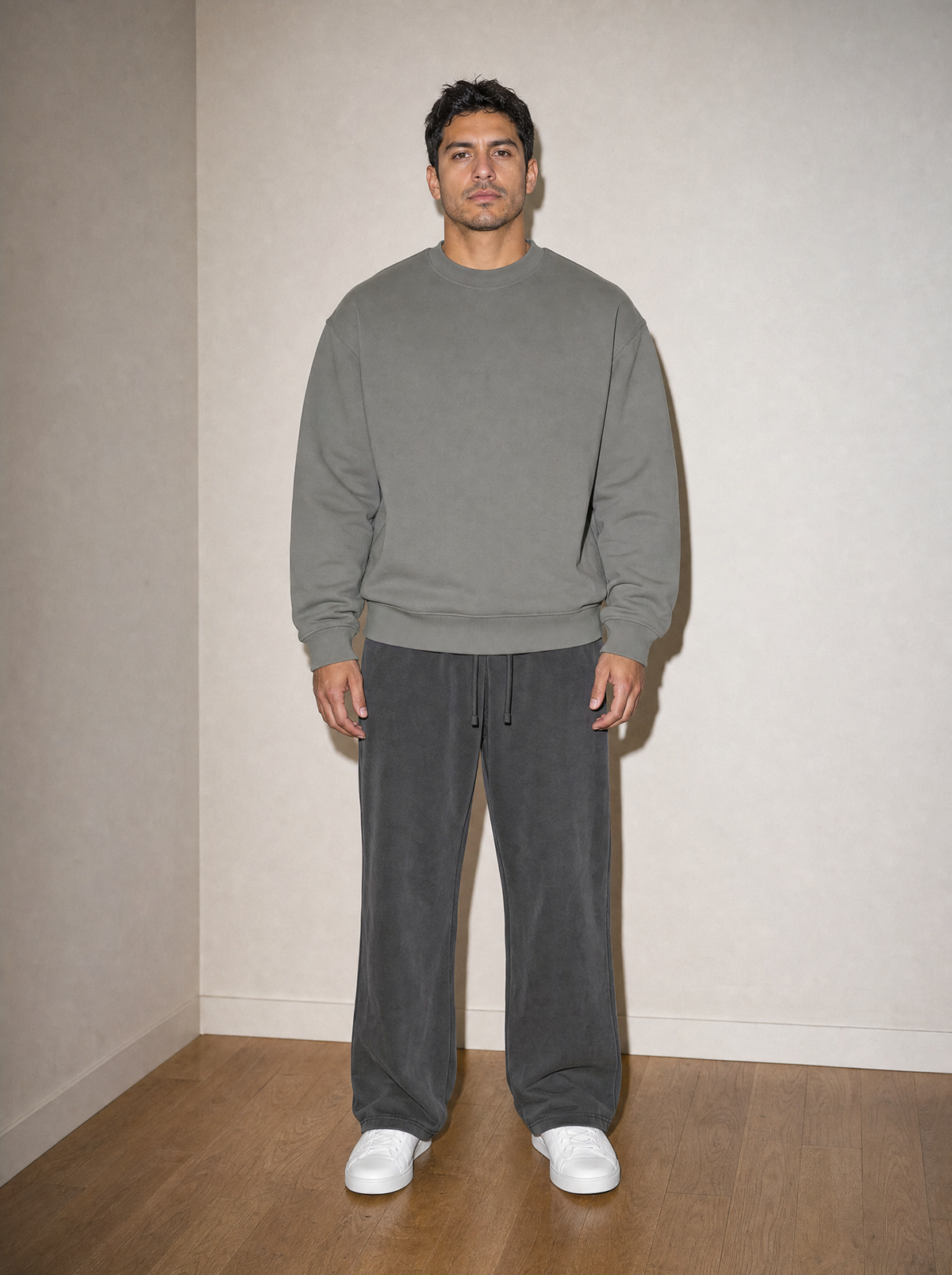 Home & Away Crewneck in Gray, front view, worn against the apartment wall: 380 gsm cotton-blend fleece with ribbed collar, cuffs and hem
