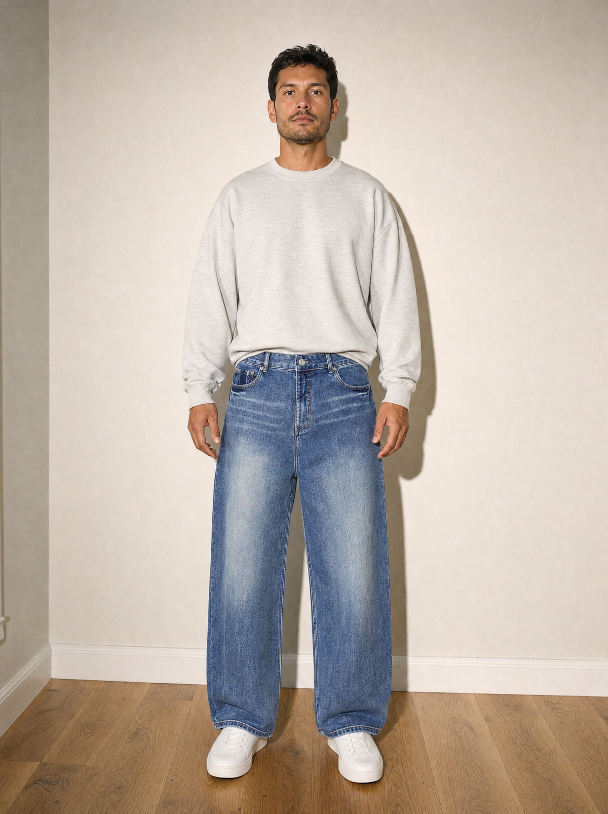 Sunfade Jean in Blue, front view, worn against the apartment wall: 543 gsm (16 oz) denim with a water-streak sun fade