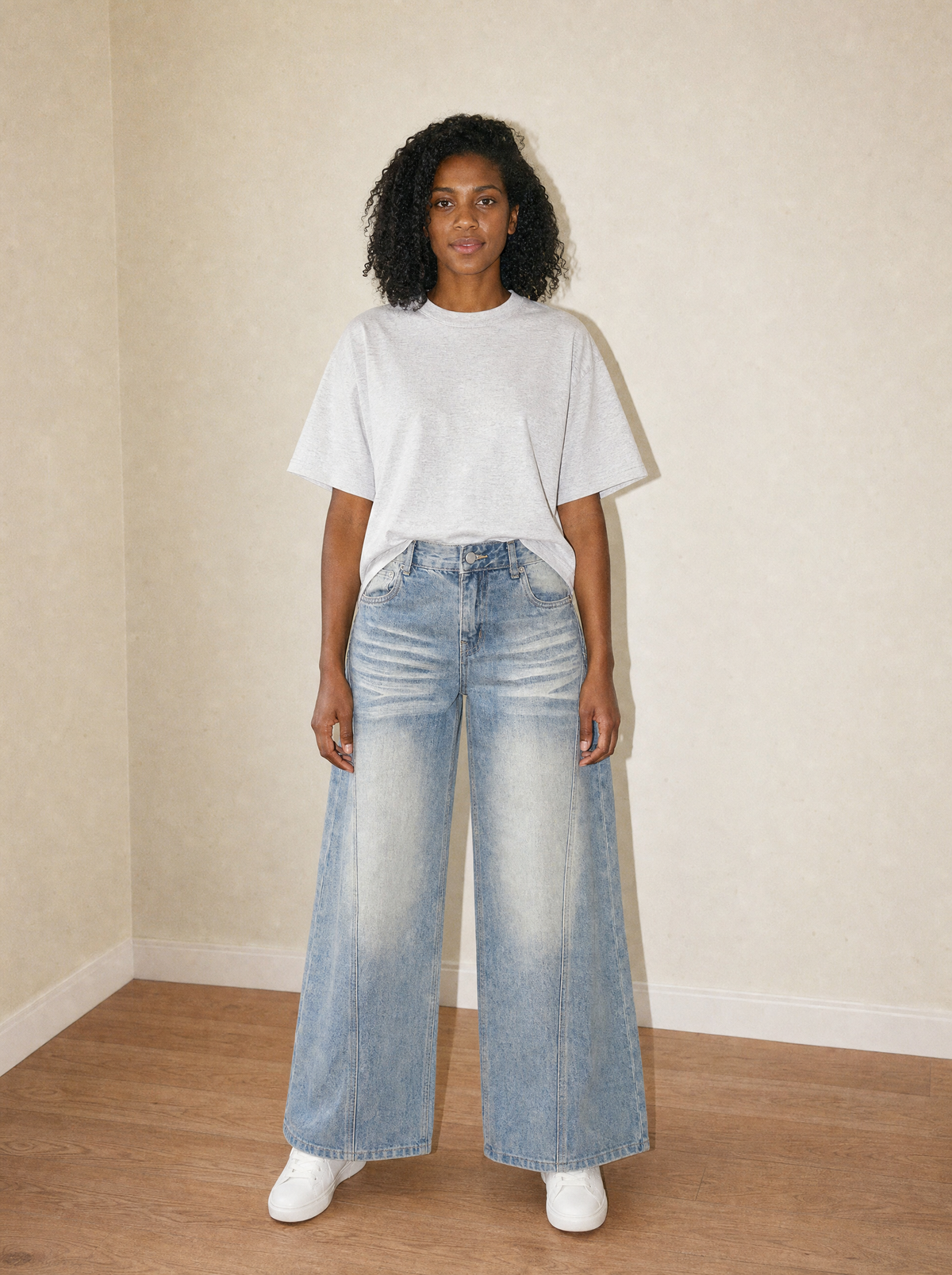Women's Vintage Wide Leg Jean in Jeans Blue, front view, worn against the apartment wall: 420 gsm cotton-lyocell denim with sun fade and whiskering